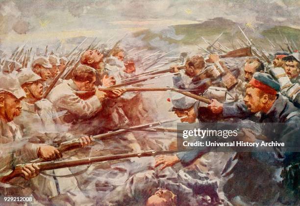 Belgian soldiers repelling a fierce German attack at Liege during World War One. From The History of the Great War, published c. 1919