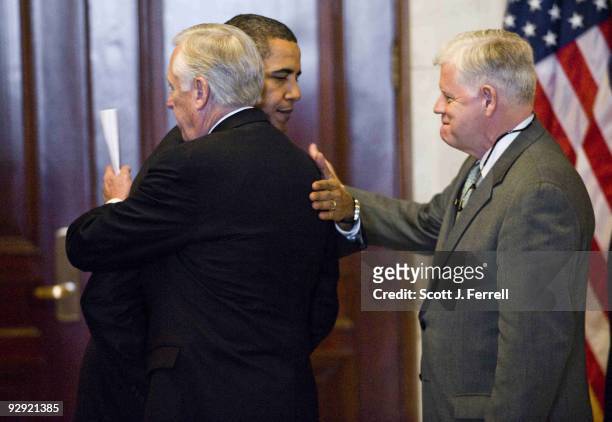 President Barack Obama embraces House Majority Leader Steny Hoyer, D-Md., as House Democratic Caucus Chairman John B. Larson, D-Conn., looks on after...