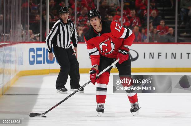 Ben Lovejoy of the New Jersey Devils plays the puck during the game against the Montreal Canadiens at Prudential Center on March 6, 2018 in Newark,...