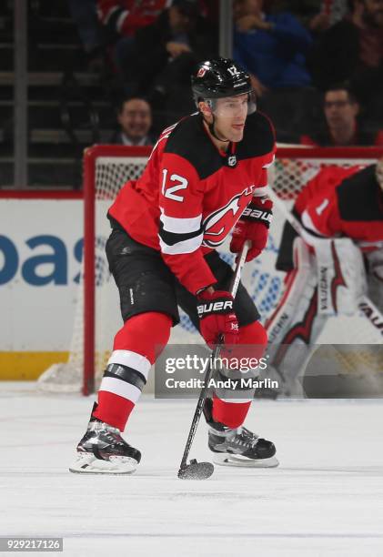 Ben Lovejoy of the New Jersey Devils plays the puck during the game against the Montreal Canadiens at Prudential Center on March 6, 2018 in Newark,...