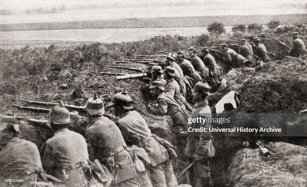 German troops firing from trenches under the direction of an officer during WWI