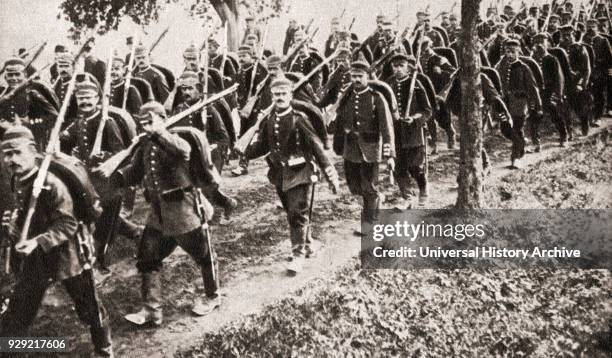 German troops marching easy through Belgium during WWI. From The Pageant of the Century, published 1934