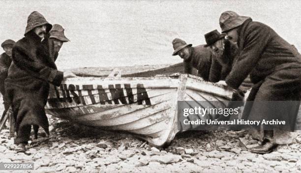 One of the lifeboats from the RMS Lusitania, sunk by a German U-boat in 1915 is hauled onto the beach on the coast of Ireland. From The Pageant of...