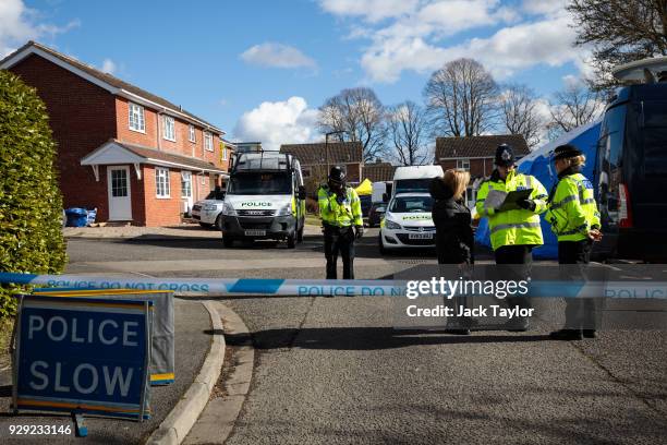 Police officers search the home of Sergei Skripal in Salisbury who was found critically ill on a bench with his daughter on March 4 and were taken to...