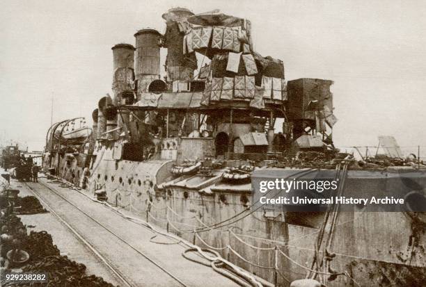 The battleship Vindictive returns to Dover after the raid on Zeebrugge in 1918 during World War One. From The Story of 25 Eventful Years in Pictures...