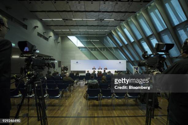 Mario Draghi, president of the European Central Bank , center, sits flanked by Vitor Constancio, vice president of the European Central Bank , left,...