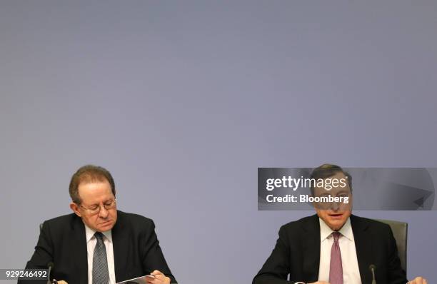 Mario Draghi, president of the European Central Bank , right, speaks as Vitor Constancio, vice president of the European Central Bank , reads a...