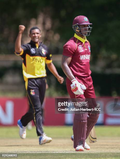 Alei Nao of Papua New Guinea celebrates the wicket of Marlon Samuels of The West Indies hits out during The Cricket World Cup Qualifier between The...