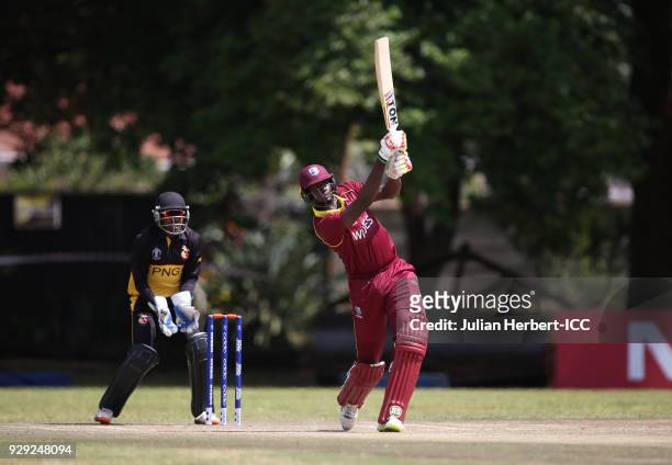 Jack Vare-Kevere looks on as Jason Holder of The West Indies hits out during The Cricket World Cup Qualifier between The West Indies and Papua New...