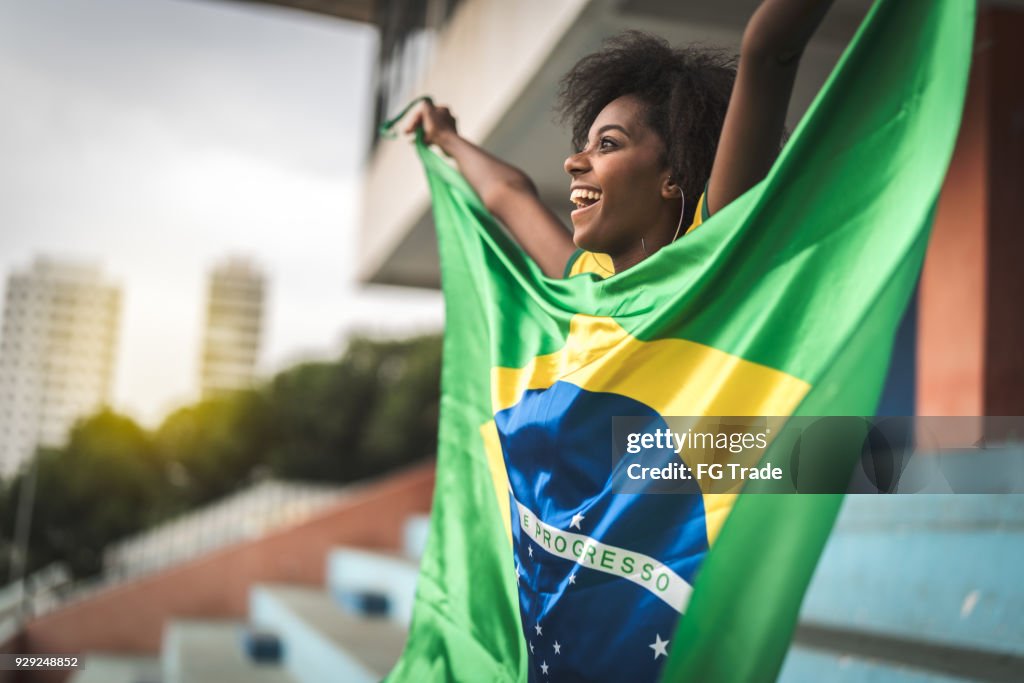 Happy Brazilian fan watching a soccer game
