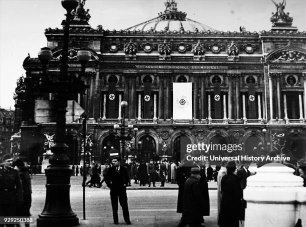 Photograph of Nazi flags hanging from the Paris Opera House, during the German occupation of France, in World War Two. Dated 20th Century.