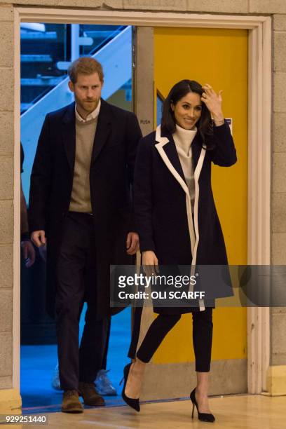 Britain's Prince Harry and his fiancee US actress Meghan Markle visit Nechells Wellbeing Centre in Birmingham on March 8, 2018 to meet Coach Core...