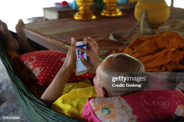 Monk using a cell phone. Cambodia.