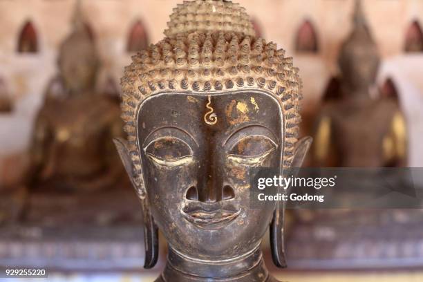Buddha statue in the cloister or gallery surrounding the Sim. Part of a collection of approximately 2000 ceramic and silver buddhas on display in the...