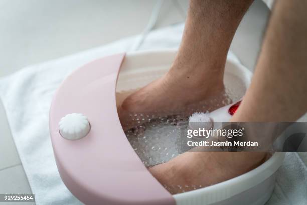 feet massage water - reflexology stock-fotos und bilder