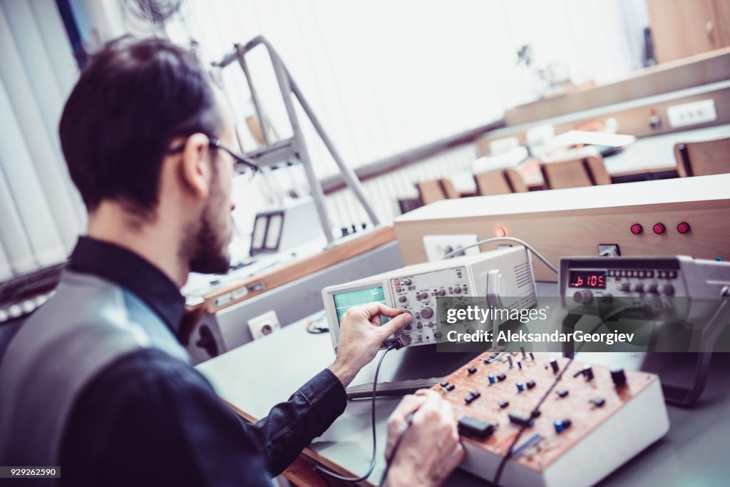 Adult Engineer Measuring in his Working Office