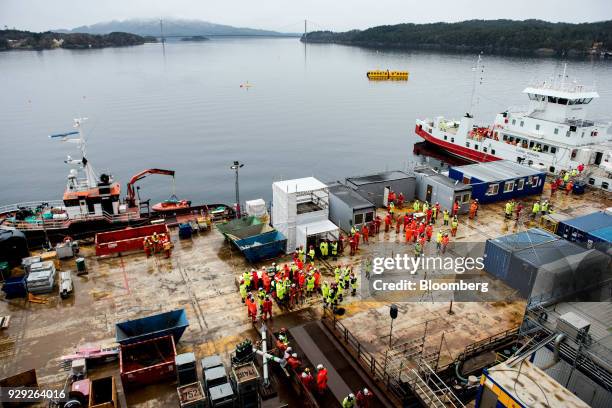 Employees and members of the media gather during the ceremonial baptism of the Aasta Hansteen gas platform operated by Statoil ASA near Stord,...