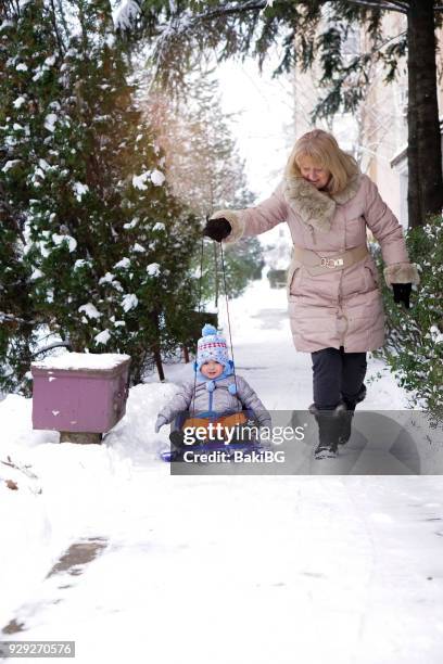 grandmother  having fun  with child in the snow - winter sport walk old stock pictures, royalty-free photos & images