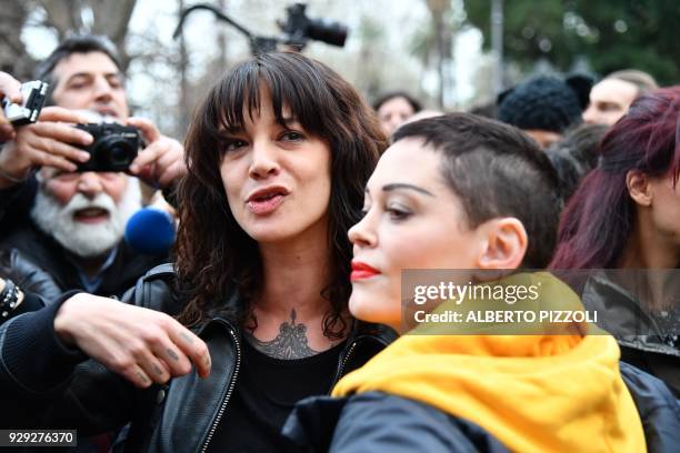 Italian actress Asia Argento and US singer and actress Rose McGowan, who both accuse Harvey Weinstein of sexual assault, take part in a march...