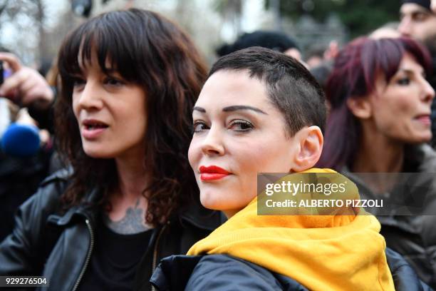 Italian actress Asia Argento and US singer and actress Rose McGowan, who both accuse Harvey Weinstein of sexual assault, take part in a march...