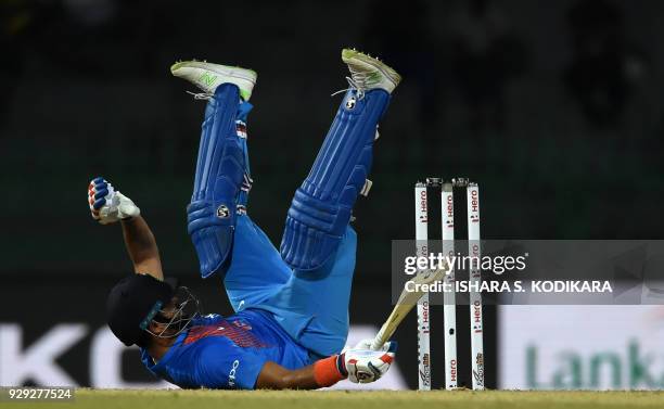 Indian cricketer Suresh Raina dives into his crease to complete a run during the second Twenty20 international cricket match between Bangladesh and...