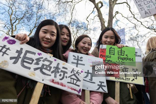 Chinese women take part in Women's Strike in London's Russel Square protesting against harassment, exploitation and discrimination experienced by...