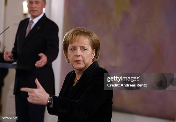 German Chancellor Angela Merkel points on as German President Horst Koehler gestures on a reception at Bellevue Castle on November 9, 2009 in Berlin,...