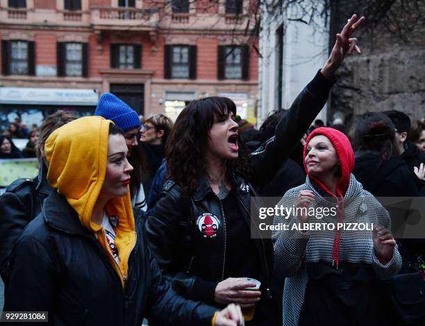 Italian actress Asia Argento and US singer and actress Rose McGowan , who both accuse Harvey Weinstein of sexual assault, take part in a march...