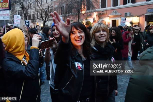 Italian actress Asia Argento and US singer and actress Rose McGowan , who both accuse Harvey Weinstein of sexual assault, take part in a march...