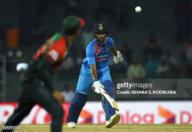 Indian cricketer Shikhar Dhawan runs between wickets during the second Twenty20 international cricket match between Bangladesh and India for the...
