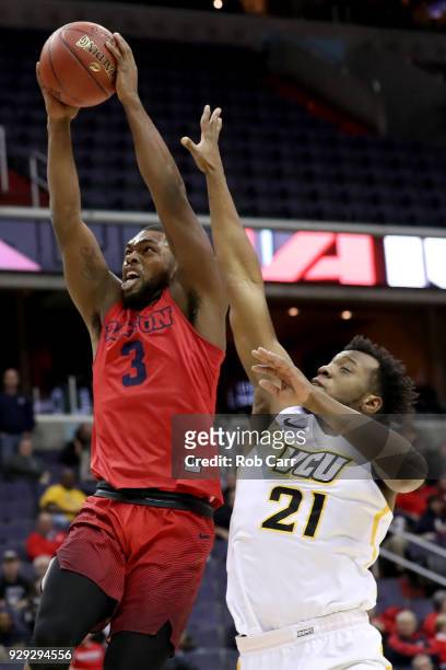 Trey Landers of the Dayton Flyers goes up for a dunk over Khris Lane of the Virginia Commonwealth Rams in the first half during the second round of...