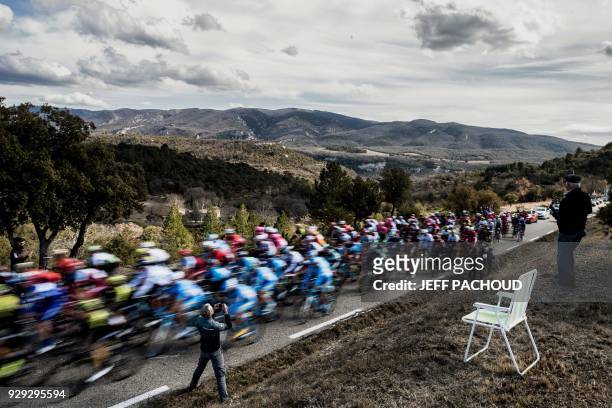 The pack rides during the 165km fifth stage of the 76th Paris-Nice cycling race between Salon de Provence and Sisteron on March 8, 2018. / AFP PHOTO...