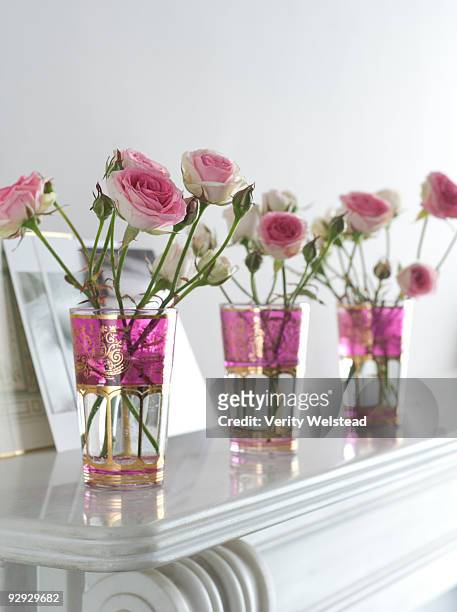 pink roses in vases on a mantelpiece - rosa mantel stock pictures, royalty-free photos & images