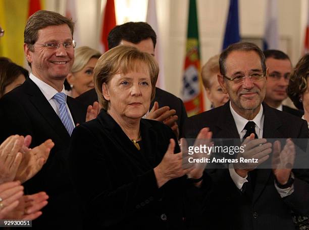 German Chancellor Angela Merkel and European Council High Representative Javier Solana claps as German Foreign Minister Guido Westerwelle smiles on a...