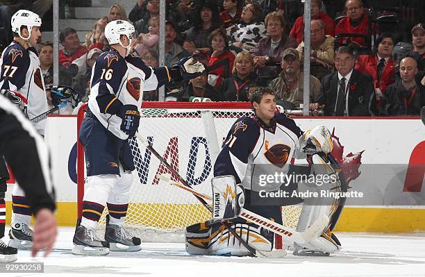 Christoph Schubert and goalie Ondrej Pavelec of the Atlanta Thrashers react after making a save without his facemask in an NHL game against the...