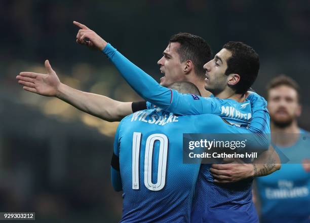 Henrikh Mkhitaryan of Arsenal celebrates with team-mates after scoring during the UEFA Europa League Round of 16 match between AC Milan and Arsenal...