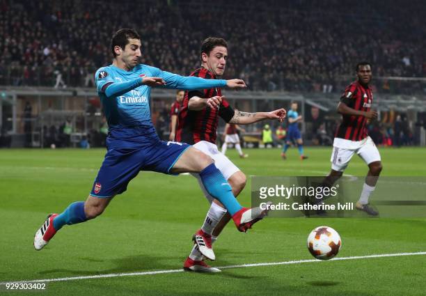 Henrikh Mkhitaryan of Arsenal is tackled by Davide Calabria of AC Milan during the UEFA Europa League Round of 16 match between AC Milan and Arsenal...