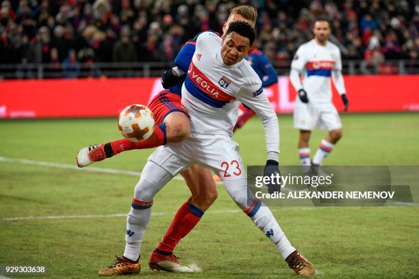 Moscow's midfielder from Sweden Pontus Wernbloom and Lyon's Dutch defender Kenny Tete vie for the ball during the UEFA Europa League round of 16...