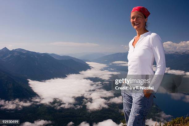 portrait of female atop mountain - slocan lake stock pictures, royalty-free photos & images