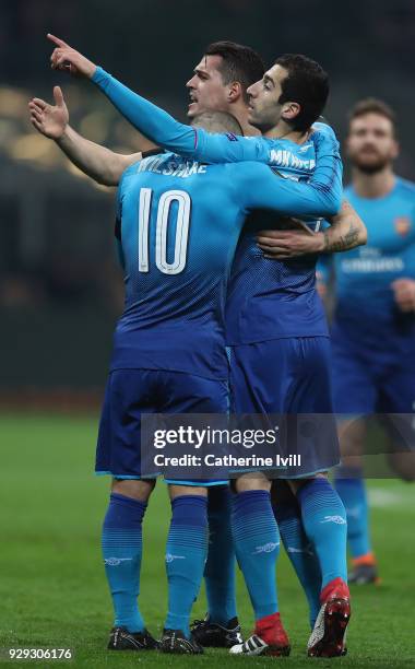 Henrikh Mkhitaryan of Arsenal celebrates with team-mates after scoring during the UEFA Europa League Round of 16 match between AC Milan and Arsenal...