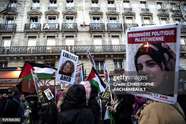 Demonstrators hold a banner reading "Free Ahed Tamimi" refering to the Palestinian teenager jailed in Israel, in Paris on March 8, 2018 during a...