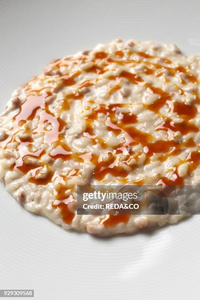 Risotto flavored with garlic and sweetbreads seasoned with Sauternes wine. Fabio Barbaglini chef. Ristorante Antica Osteria del Ponte restaurant....