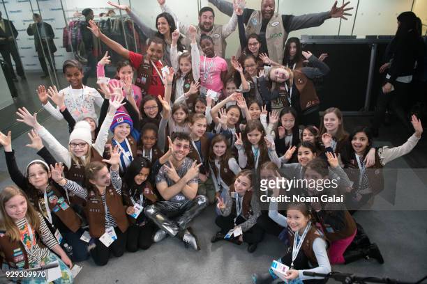 Singer MAX poses for a photo with Girl Scouts at SiriusXM 'Hits 1' at SiriusXM Studios on March 8, 2018 in New York City.