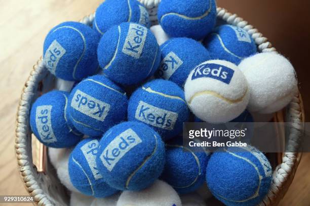 Tennis balls with Keds branding on display as Keds celebrates International Women's Day with Violetta Komyshan at Manhattan Plaza Racquet Club on...