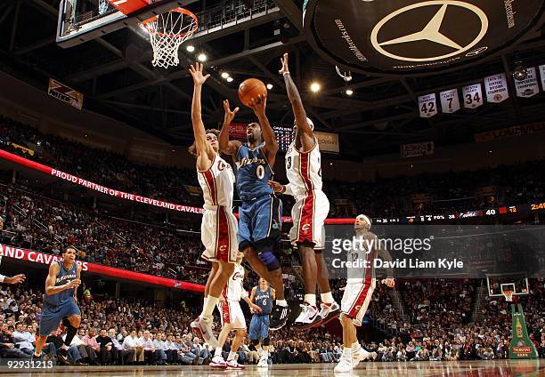 Gilbert Arenas of the Washington Wizards drives to the basket for a layup between Anderson Varejao and LeBron James of the Cleveland Cavaliers during...
