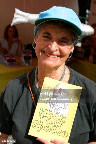 An author holding her book at the Miami International Book Fair.