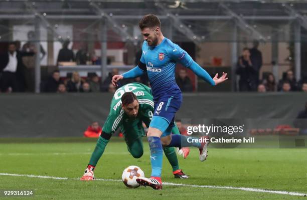 Aaron Ramsey of Arsenal rounds AC Milan goalkeeper Gianluigi Donnarumma to score during the UEFA Europa League Round of 16 match between AC Milan and...