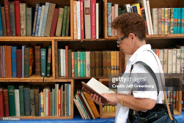 Woman browsing books at the Miami International Book Fair.