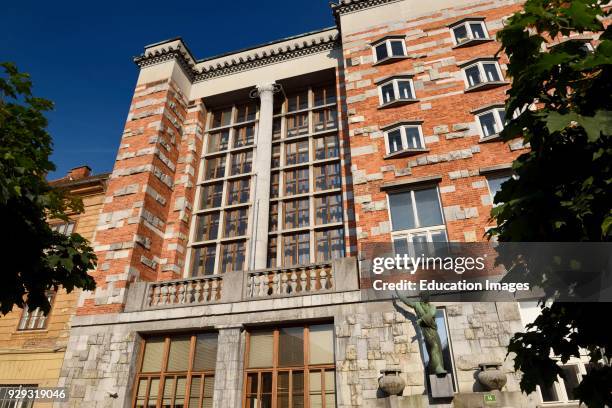 National and University Library of Slovenia in Ljubljana by architect Joze Plecnik with sculpture of Moses by Dolinar next to old Vzigalica Gallery.