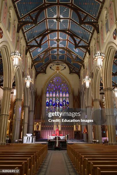 Wide view of renovated St Michael's Cathedral Toronto with pews and ceiling.